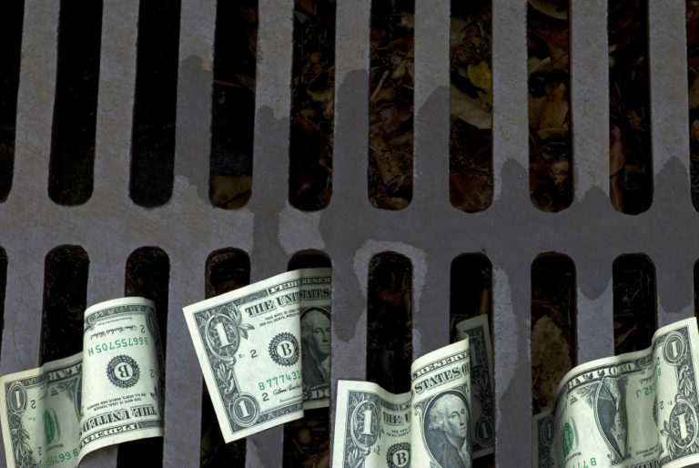 us-dollar-bills-down-drain